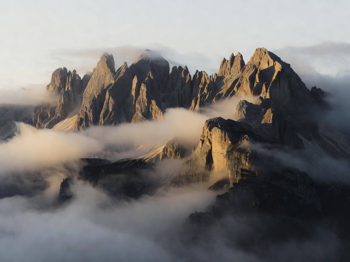 The same Dolomites ridgeline in low morning side light with strong shadows and valley mist
